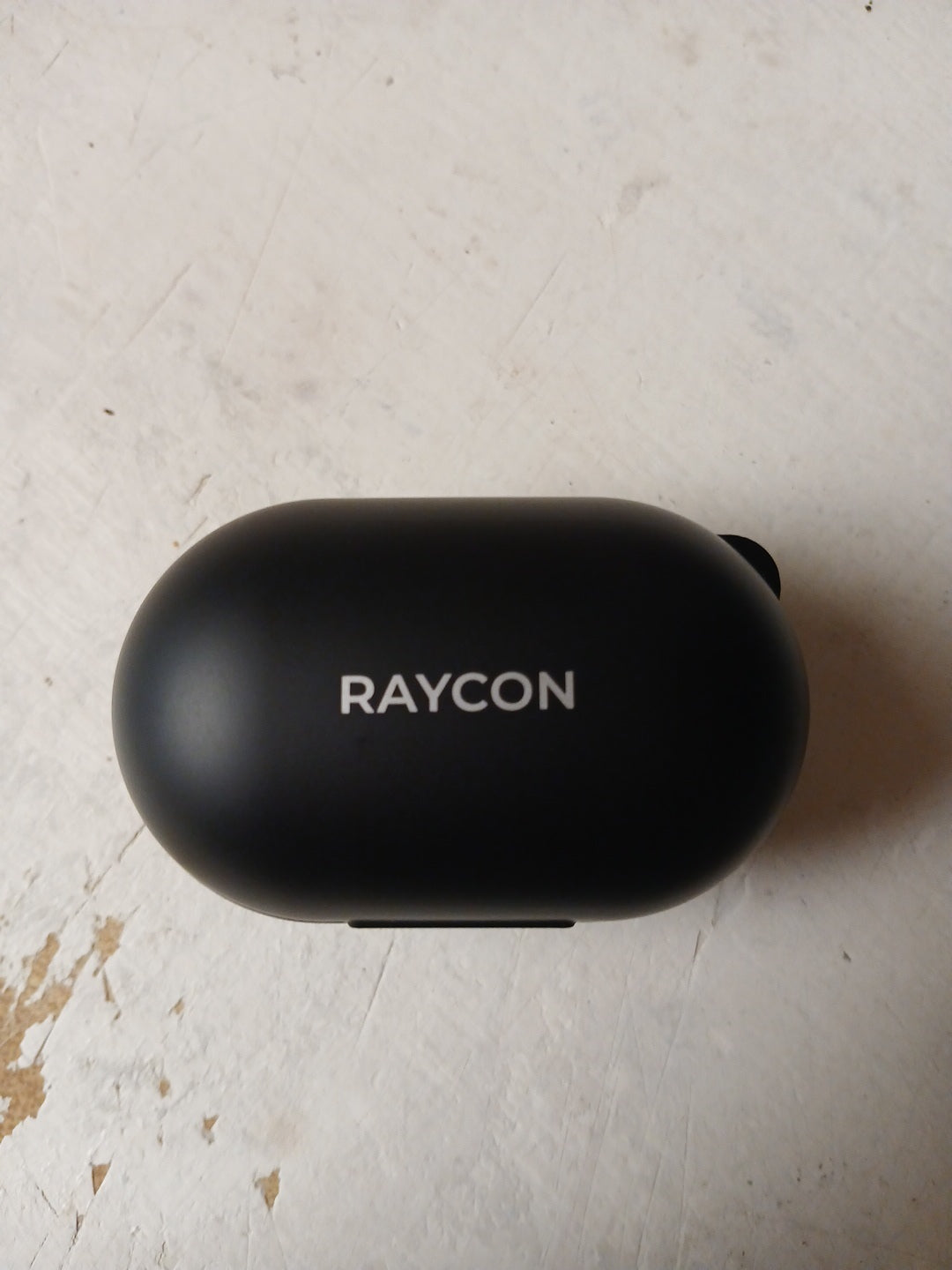 Black case with 'RAYCON' branding on a light surface