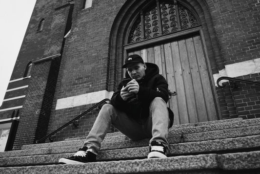 man sitting on stair near door