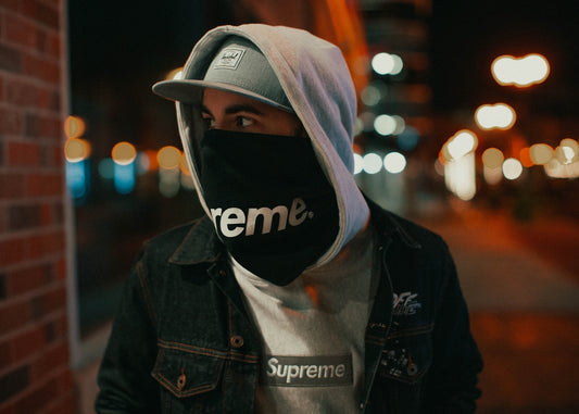 man in black and white adidas hoodie wearing white and black nike cap