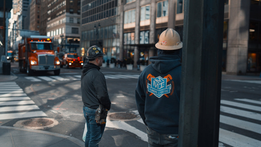 a couple of men standing on the side of a road
