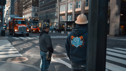 a couple of men standing on the side of a road