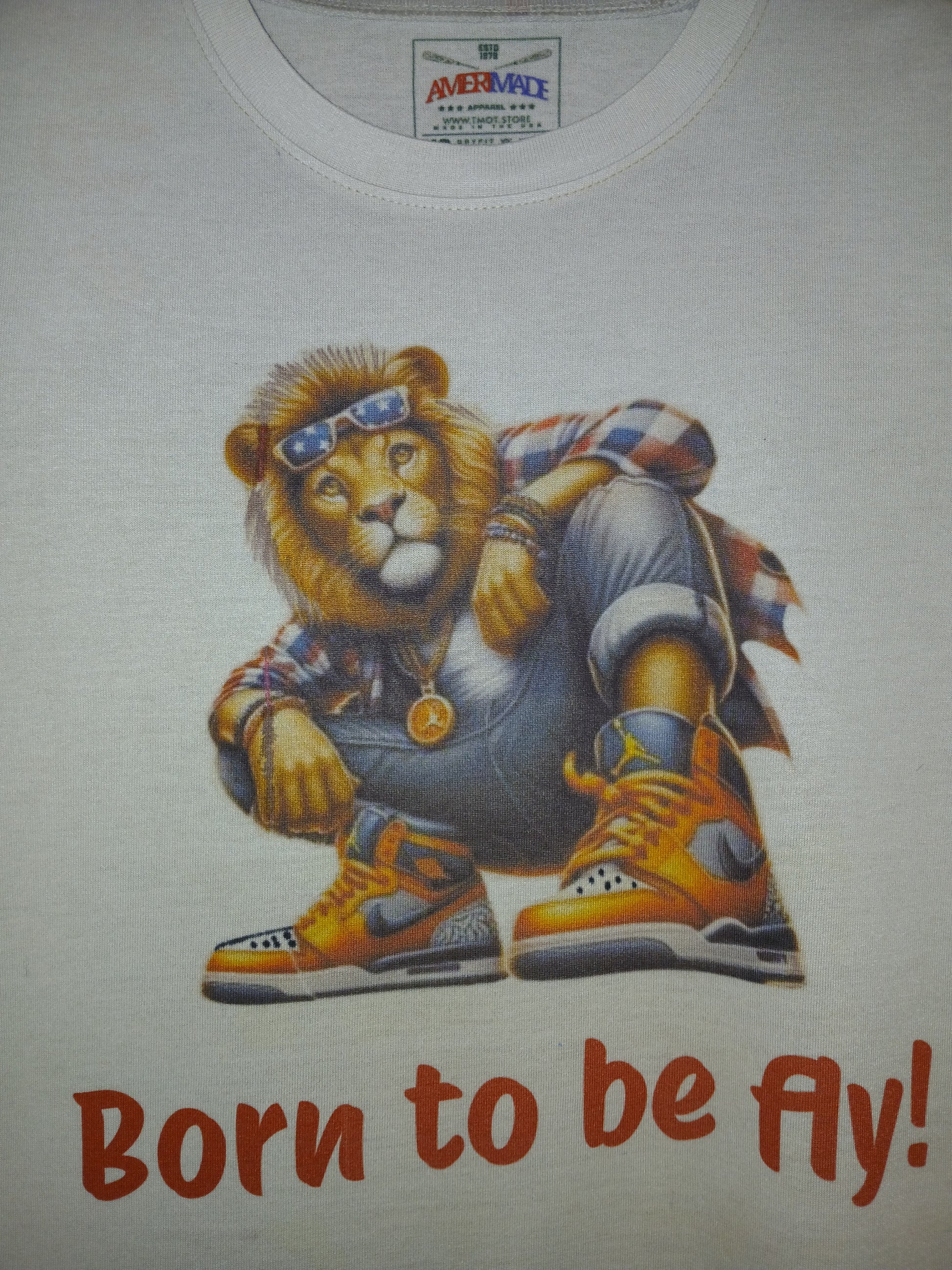 T-shirt with a lion graphic and 'Born to be Fly!' text on a white background