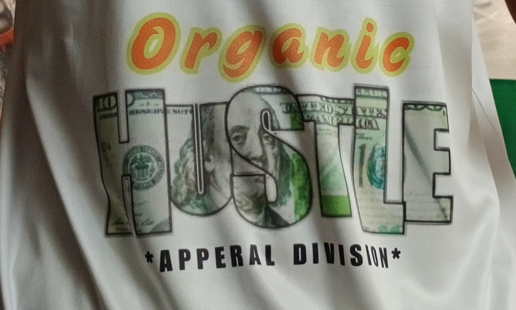 T-shirt with 'Organic Hustle' design featuring dollar bills and text on a white background