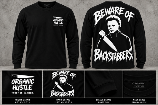 Illustrative front-and-back mockup of Beware of Backstabbers long-sleeve black tee; artwork and details shown for presentation