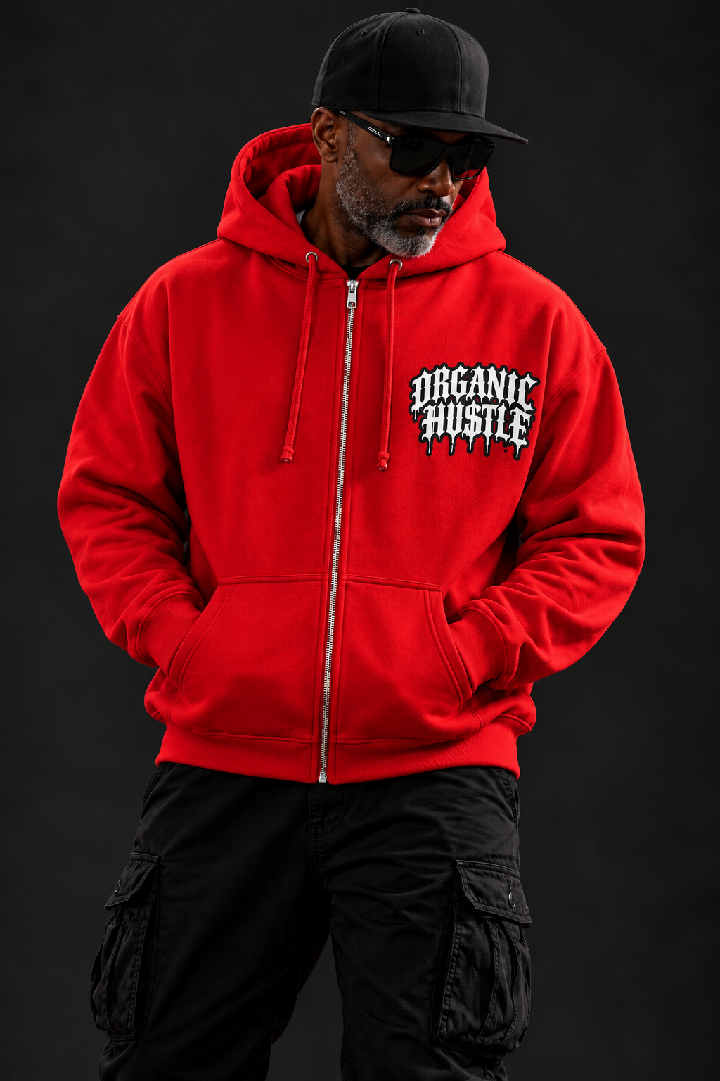 Studio styling mockup of the red Organic Hu$tle Guardian Angel hoodie showing full-length front zipper and white chest logo