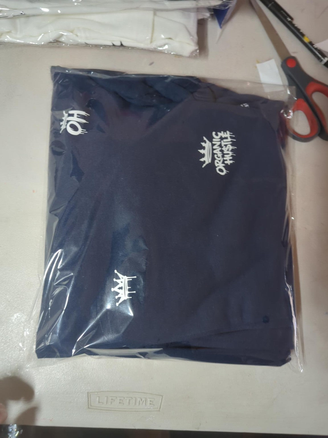 Actual packaged navy blue Organic Hu$tle sweatpants size L, second view