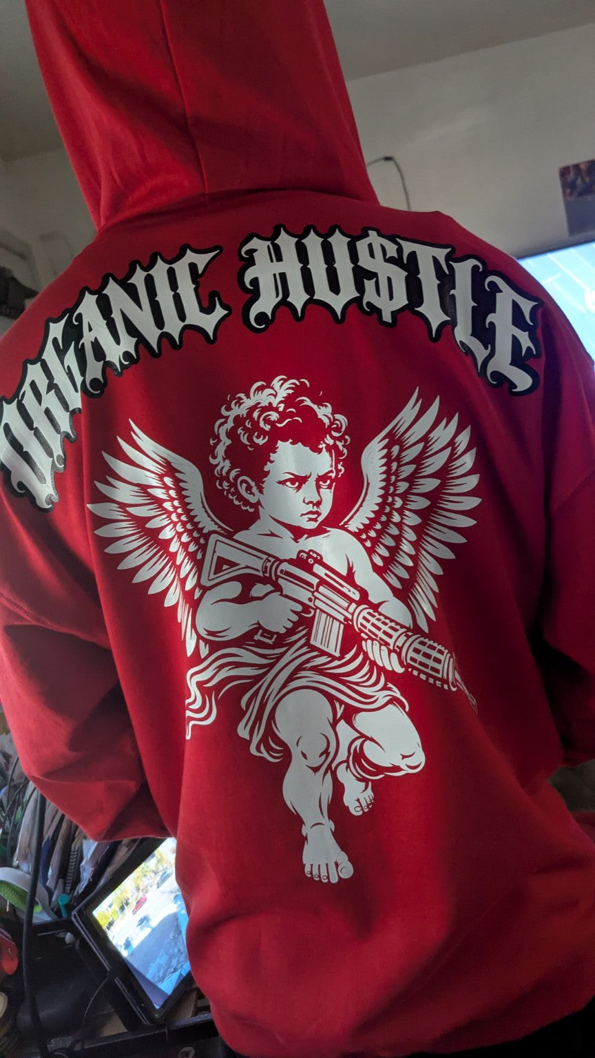 Close-up of the Guardian Angel hoodie graphic showing a white winged cherub holding a rifle
