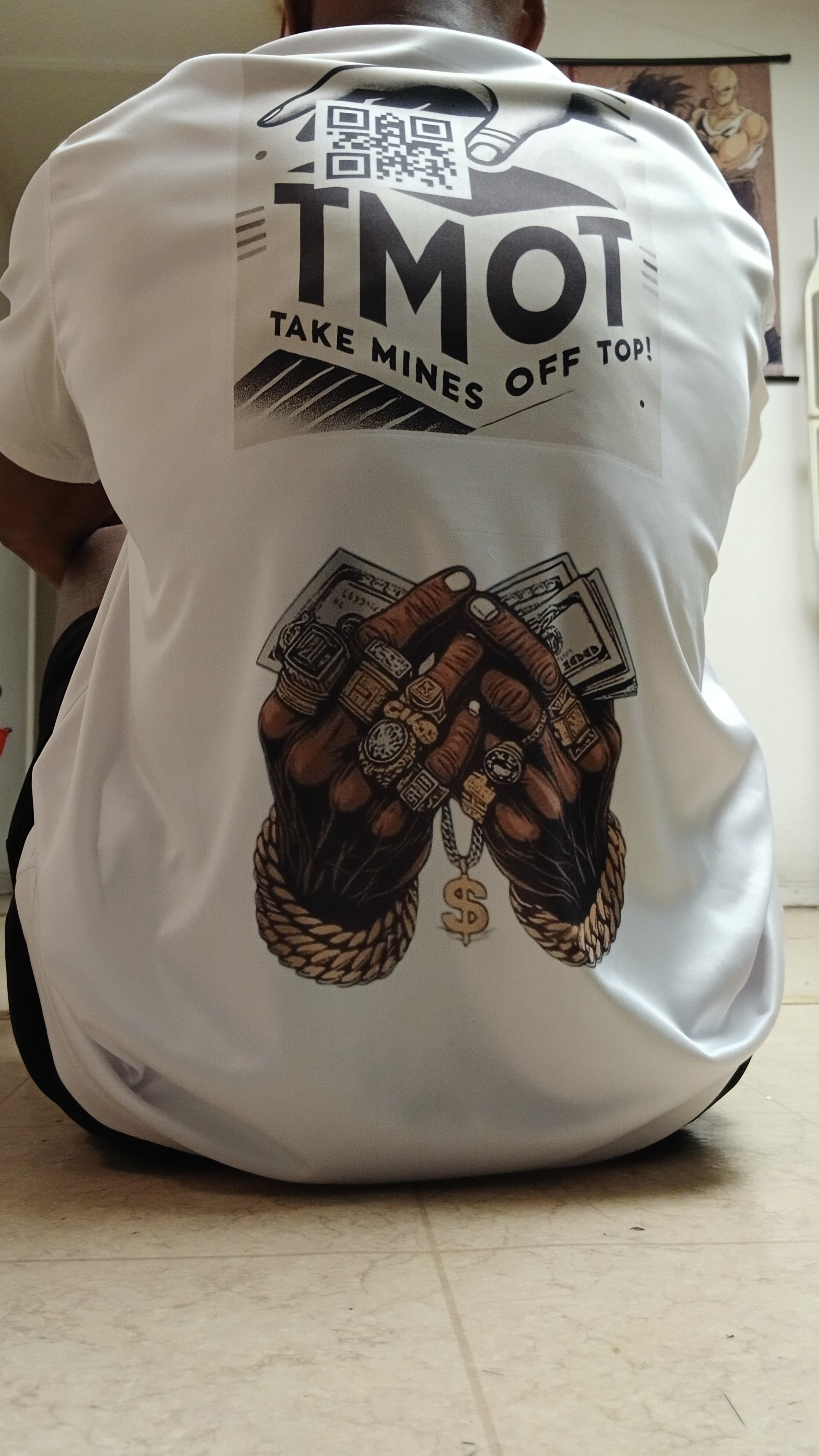 White sleeveless shirt with graphic design and text on a plain background